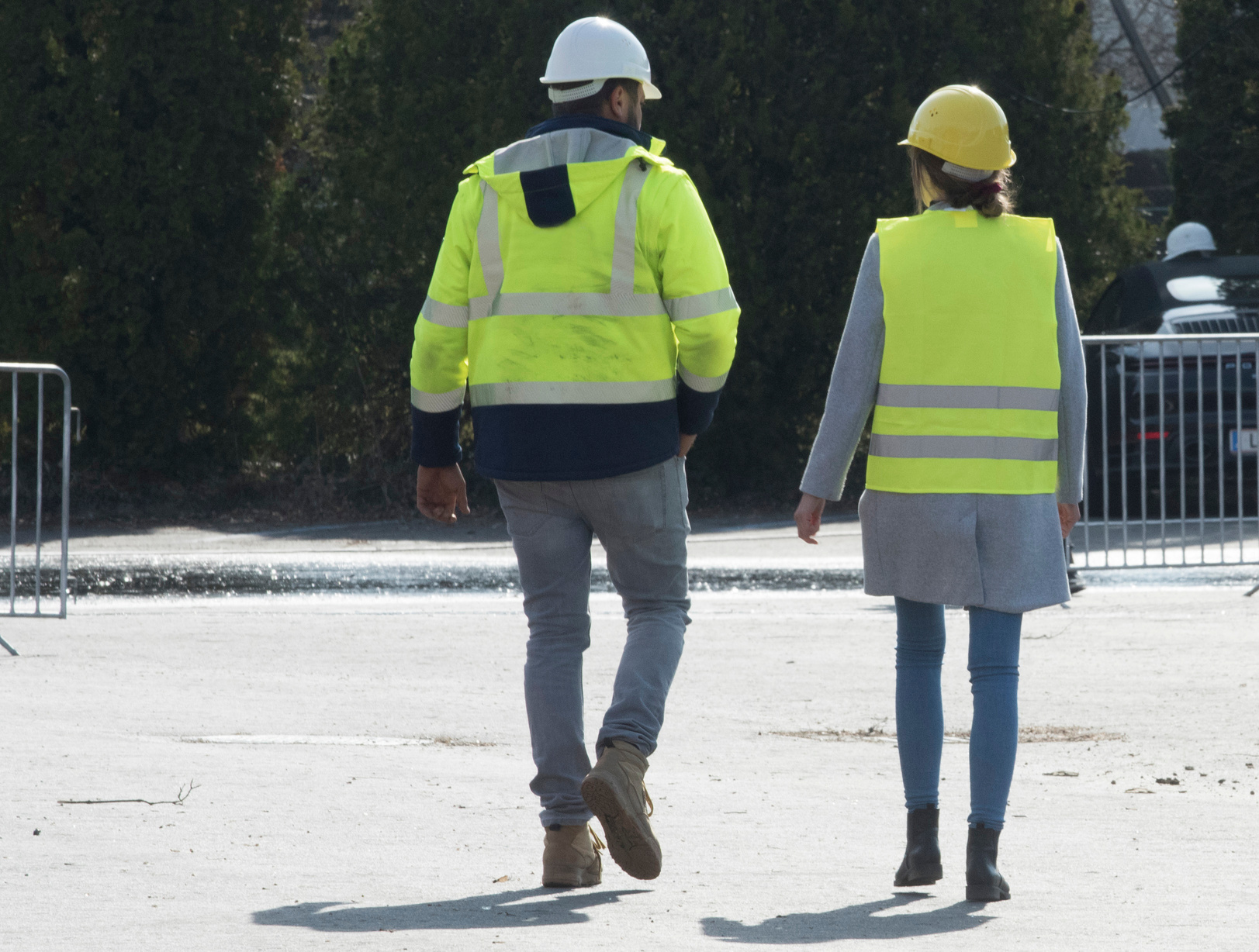 Workers in Green Safety Vests Walking Outdoors